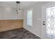Bright entryway featuring stylish light fixtures, wood accent wall, decorative door, and luxury vinyl plank flooring at 127 Nautical Dr, North Port, FL 34287