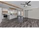 Open living area with grey wood-look flooring and ceiling fan at 127 Nautical Dr, North Port, FL 34287
