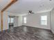 Spacious main bedroom featuring luxury vinyl plank flooring, natural light, barn door access to ensuite bath at 127 Nautical Dr, North Port, FL 34287