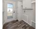 Convenient mud room featuring LVP flooring, exterior access, and built-in shelving at 127 Nautical Dr, North Port, FL 34287