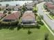 An aerial view of the single story home with a pool and a large backyard at 13240 Amerigo Ln, Venice, FL 34293