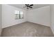 Spacious bedroom with carpeted floors and a ceiling fan at 13240 Amerigo Ln, Venice, FL 34293