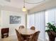 Cozy dining area with a round table and chairs, near a window at 200 Park N Blvd # 103, Venice, FL 34285