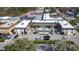 Aerial view of condo complex featuring a pool and surrounding parking at 200 Park N Blvd # 103, Venice, FL 34285