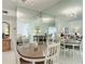 Bright dining room with an oval table, chairs, and mirrored walls at 200 Park N Blvd # 103, Venice, FL 34285