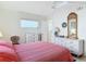 Bedroom with double bed, ceiling fan, and white dresser at 200 Park N Blvd # 103, Venice, FL 34285