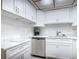 White kitchen with stainless steel dishwasher and marble countertops at 200 Park N Blvd # 103, Venice, FL 34285