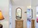 Hallway with mirror and antique cabinet leading to bedrooms at 200 Park N Blvd # 103, Venice, FL 34285