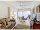 Bright living room features comfy seating, a large TV, and an area rug at 200 Park N Blvd # 103, Venice, FL 34285