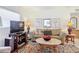 Living room with sofa, coffee table, and entertainment center at 200 Park N Blvd # 103, Venice, FL 34285