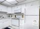 White kitchen with stainless steel appliances and marble countertops at 200 Park N Blvd # 103, Venice, FL 34285