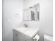 Simple bathroom with gray vanity, white toilet and a large mirror at 2129 Inner Cass Cir, Sarasota, FL 34231