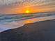 Beautiful sunset over the ocean with waves rolling onto the sandy beach at 231 Victoria Rd, Venice, FL 34293