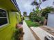 Exterior view of a well-maintained property with a walkway surrounded by lush landscaping and a welcoming entrance at 231 Victoria Rd, Venice, FL 34293