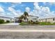 Landscaped manufactured home with carport and palm trees at 472 Sharks Pt, North Port, FL 34287