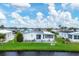 White manufactured home with canal-front view in a 55+ community at 472 Sharks Pt, North Port, FL 34287