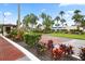 Gated entrance to Harbor Isles, featuring brick pavers and landscaping at 472 Sharks Pt, North Port, FL 34287