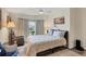 Bedroom with a queen bed, armchair, and window at 472 Sharks Pt, North Port, FL 34287