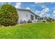 Side view of a white manufactured home with a manicured lawn at 472 Sharks Pt, North Port, FL 34287