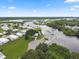 Aerial view of waterfront community with boat docks and homes at 472 Sharks Pt, North Port, FL 34287