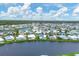 Aerial view of waterfront community with numerous homes and lush landscaping at 472 Sharks Pt, North Port, FL 34287