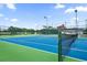 Tennis court with a net, ready for a friendly match at 472 Sharks Pt, North Port, FL 34287