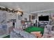 Sunroom with couches, a kitchen view, and green carpeting at 472 Sharks Pt, North Port, FL 34287
