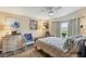 Bedroom with a queen bed, wicker furniture, and window at 472 Sharks Pt, North Port, FL 34287