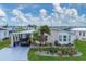 Community of manufactured homes near the water with lush landscaping at 472 Sharks Pt, North Port, FL 34287