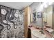 Bathroom with pink vanity, shower, and nautical-themed decor at 472 Sharks Pt, North Port, FL 34287
