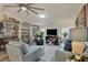 Spacious living room with light gray leather sofas and built-in shelving at 472 Sharks Pt, North Port, FL 34287