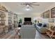 Living room with gray leather sofas, ceiling fan, and large TV at 472 Sharks Pt, North Port, FL 34287