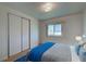 Bedroom with wood-look flooring, a queen bed, and sliding closet doors at 529 Cervina Drive S, Venice, FL 34285