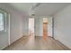 Bright bedroom with light wood flooring, leading to bathroom and closet at 529 Cervina Drive S, Venice, FL 34285