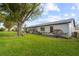 House exterior view, showcasing backyard and landscaping at 605 Apple Ln, Englewood, FL 34223
