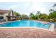 Inviting community pool with brick deck and ample lounge space at 605 Apple Ln, Englewood, FL 34223