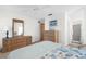 Spacious bedroom with dresser and large mirror at 605 Apple Ln, Englewood, FL 34223