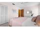 Bedroom with a queen bed, white dresser, and window coverings at 605 Apple Ln, Englewood, FL 34223