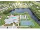 Community pool, tennis courts, shuffleboard, and lake view at 605 Apple Ln, Englewood, FL 34223