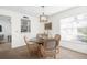 Charming dining area with a glass-top table and four chairs at 605 Apple Ln, Englewood, FL 34223