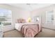 Bright bedroom with a queen-size bed and light pink bedding at 605 Apple Ln, Englewood, FL 34223