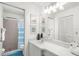 Clean bathroom with vanity, shower, and linen closet at 605 Apple Ln, Englewood, FL 34223