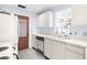 White kitchen with ample counter space and a view to the dining area at 605 Apple Ln, Englewood, FL 34223