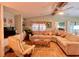 Spacious living room, featuring a large sectional sofa and a ceiling fan at 786 Heathercreek Ct, Englewood, FL 34223