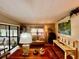 Living room with beige couch, wood floors, and large windows at 786 Heathercreek Ct, Englewood, FL 34223