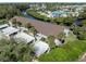 Aerial view of condo community near waterfront with lush landscaping at 841 Waterside Dr # 206, Venice, FL 34285