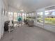 Bright sunroom with ample seating and view of the backyard at 1141 Sleepy Hollow Ct, Venice, FL 34285