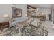 Living room with comfy seating, large artwork, and view to dining area at 1141 Sleepy Hollow Ct, Venice, FL 34285
