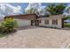 Updated home exterior with stone, siding, and a large paved driveway at 1141 Sleepy Hollow Ct, Venice, FL 34285