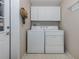 Convenient laundry room with washer, dryer, and overhead cabinets at 1141 Sleepy Hollow Ct, Venice, FL 34285